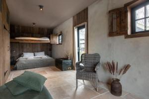 a bedroom with a bed and a chair in a room at The Meetinn in Waverveen