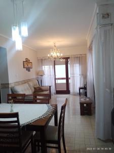 a living room with a dining table and a couch at Departamento frente al Mar. in Mar del Plata