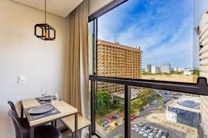 a balcony with a table and a view of a city at Apart Hotel Centro de Brasília - Garvey Park Hotel in Brasilia