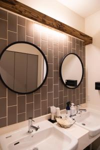 a bathroom with a sink and a mirror at HOTEL BOTH in Shari