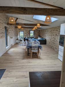 a dining room with a table and chairs at Maison de Vacances 12min du Puy du fou grand studio in Saint-Laurent-sur-Sèvre