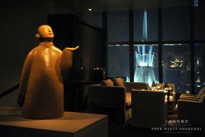 a mannequin sitting on a table in a room at Park Hyatt Shanghai in Shanghai
