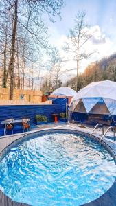 a large swimming pool with two tents in a yard at ozlifesapanca dome in Sapanca