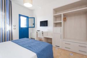 a bedroom with a bed and a desk in it at Petruso Resort in Balestrate +37 photos