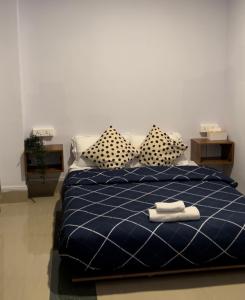 a bedroom with a blue bed with two pillows at Iranyai Homestay in Imphal