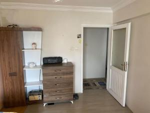 a room with a bedroom with a dresser and a door at Apartmen in Mudanya in Mudanya