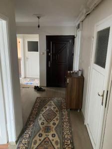 a hallway with a door and a rug on the floor at Apartmen in Mudanya in Mudanya