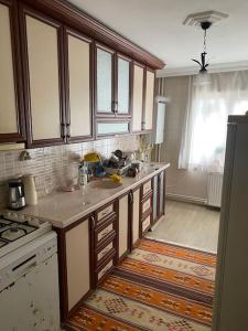 a kitchen with wooden cabinets and a counter top at Apartmen in Mudanya in Mudanya