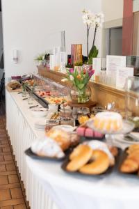 a buffet line with plates of food on it at HOTEL MARIA in Gramatneusiedl