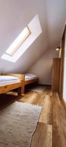 a attic room with a bed and a skylight at Chata pod kopcom in Žarnovica