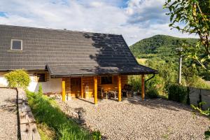 a house with a black roof on a hill at Chata pod kopcom in Žarnovica