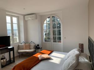 1 dormitorio con 1 cama, TV y ventanas en Villa Harriet en Uhart-Cize