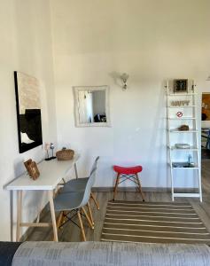 カラン・ボッシュにあるChalet Mariventのテーブル、椅子、鏡が備わる客室です。