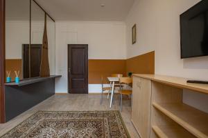 a living room with a table and a television at White House 3 in Truskavets