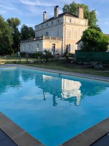 a house with a pool in front of it at La maison au cèdre in Marsac-sur-lʼIsle