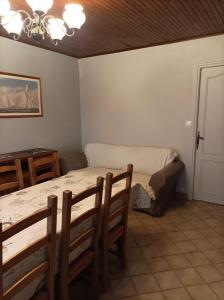a bedroom with a bed and a table and chairs at Le mas de la Treille 