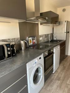 a kitchen with a washing machine and a sink at Le Suquetan in Cannes