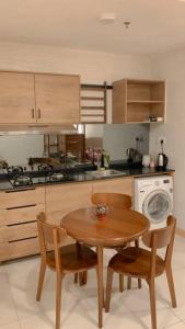 a kitchen with a wooden table and chairs and a stove at Familia Holiday @ TimurBay Seafront Kuantan in Kuantan