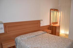 A bed or beds in a room at Hotel Ariston
