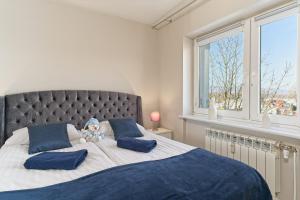 a bedroom with a large bed with blue pillows at APARTAMENT DWUPOZIOMOWY ZACHÓD SŁOŃCA - Kowary koło Karpacza in Kowary