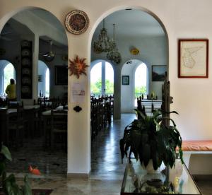 a restaurant with arches and tables and a potted plant at Hotel Villa Furia in Bellaria-Igea Marina