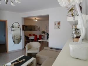 a living room with a couch and a mirror at Eco friendly apartment in Ližnjan
