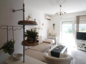 a living room with a couch and a table at Eco friendly apartment in Ližnjan