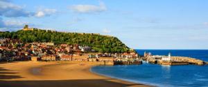 a view of a beach with a town on a hill at Dalis Den Lodge in Bridlington