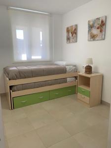 een slaapkamer met een bed, een raam en een tafel bij APARTAMENTO PEÑISCOLA PRIMERA LINEA con PISCINA in Peñíscola