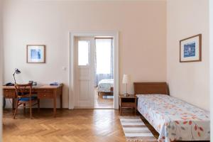 a bedroom with a bed and a desk and a deskablish at Sibelius Apartments in Prague