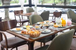 a table with food on it in a restaurant at Pousada Do Conde in Campos do Jordão