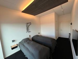 a bedroom with two beds in a room at Vojens Motorsport Arena in Vojens