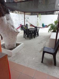 un patio con mesa, sillas y un árbol en posada barrios mar en Cartagena de Indias