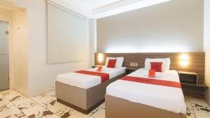 Postel nebo postele na pokoji v ubytování RedDoorz at V Plaza Hotel Manila