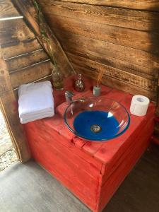 a bathroom with a blue sink on a wooden counter at Go Wild Glamping in Sibiu