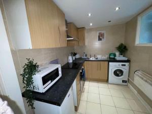 a kitchen with a microwave sitting on a counter at Stylish Cosy Studio Apartment in Kent