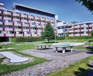 two picnic tables in a park in front of a building at Bergerlebnis Natur pur in Sankt Englmar