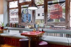 a bar with a bench and a table and a window at Clink261 Hostel in London
