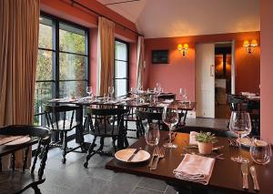 a dining room with a table with wine glasses at The Kings Head in Dorking