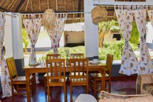 comedor con mesa y sillas en Private room in a villa en Diani Beach