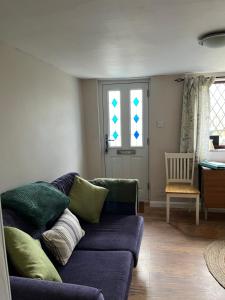 a living room with a couch and a chair at Turning Tides Holiday Cottage in Great Yarmouth
