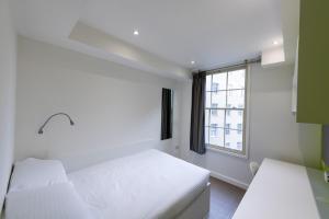a bedroom with a white bed and a window at University of Bath City Accommodation in Bath