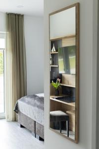een spiegel voor een slaapkamer met een bed bij Kadir Bey & Four Rooms in Osterrönfeld