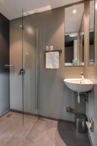y baño con lavabo y ducha. en ClinkNOORD Hostel, en Ámsterdam