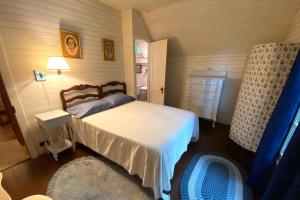 a bedroom with a bed and a dresser at Beach Retreat in Harbor Springs