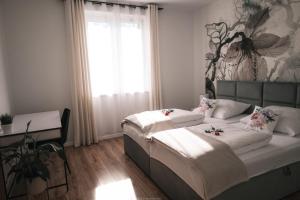 a bedroom with two beds and a desk in it at Apartament Komfort in Słupsk