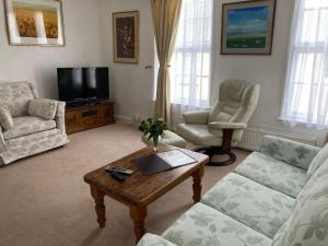 a living room with a couch and a coffee table at Grade II Listed Georgian Town House in South Molton
