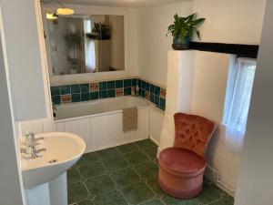 a bathroom with a sink and a toilet and a tub at Grade II Listed Georgian Town House in South Molton