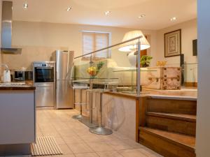 a kitchen with stainless steel appliances and a sink at Pass the Keys Montpellier mews home with parking and garden in Cheltenham