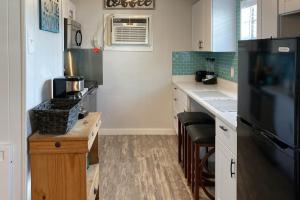 a kitchen with a black refrigerator and a counter at Sunnyside Studio in Panama City Beach
